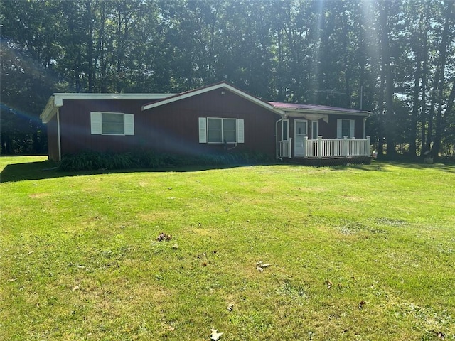 ranch-style home with covered porch and a front lawn