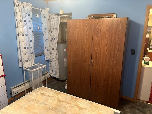 carpeted bedroom with a closet, gas water heater, and baseboard heating