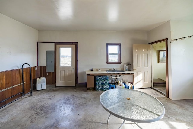 interior space featuring electric panel, sink, and a wealth of natural light