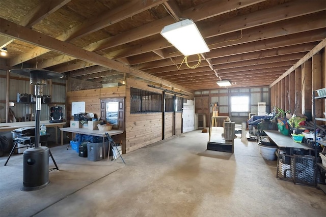 basement featuring wooden walls