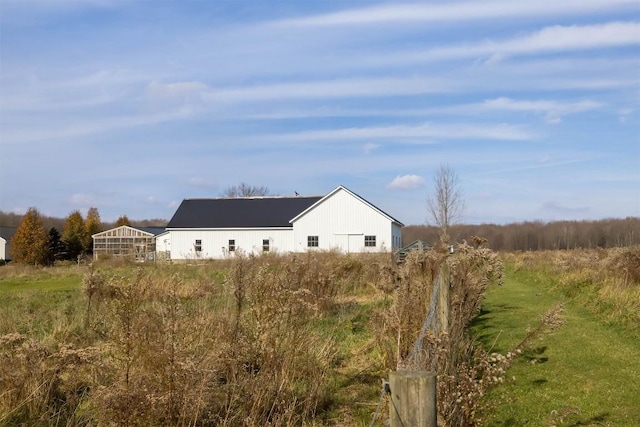 view of home's exterior with an outbuilding