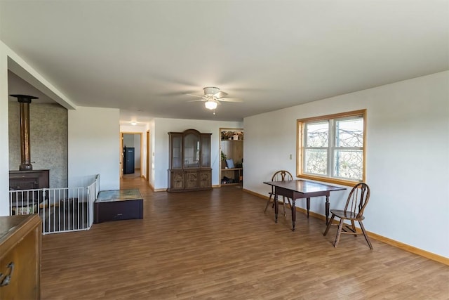 dining space featuring ceiling fan and dark hardwood / wood-style flooring