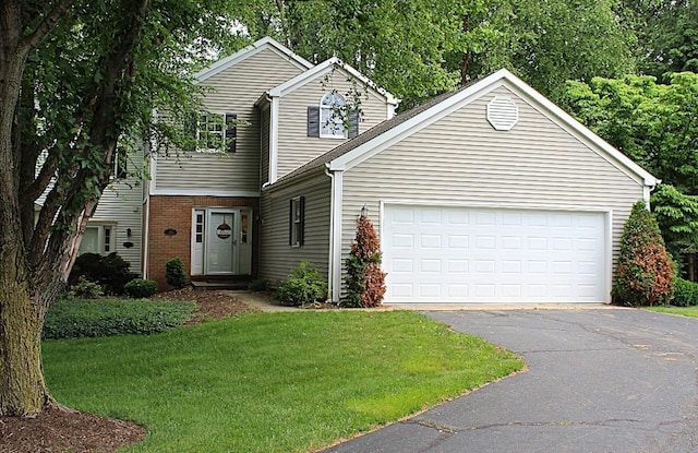 1351 Top Rd, Erie, PA 16505 - view of front of house featuring a front lawn, asphalt driveway, an attached garage, and brick siding