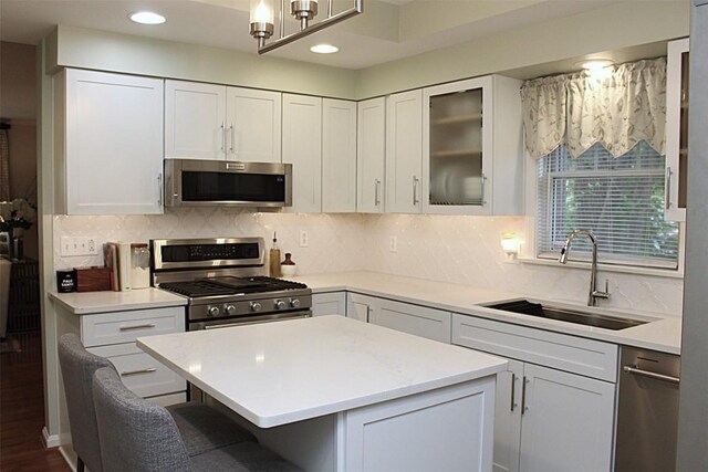 1351 Top Rd, Erie, PA 16505 - kitchen with appliances with stainless steel finishes, light countertops, a breakfast bar, white cabinets, and recessed lighting
