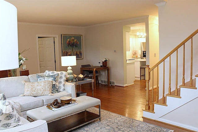 1351 Top Rd, Erie, PA 16505 - living room featuring wood finished floors, a chandelier, crown molding, and stairway