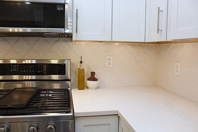 1351 Top Rd, Erie, PA 16505 - kitchen featuring stainless steel appliances, light countertops, backsplash, and white cabinetry