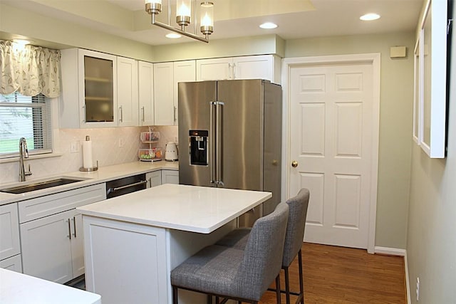1351 Top Rd, Erie, PA 16505 - kitchen featuring stainless steel appliances, recessed lighting, wood finished floors, white cabinetry, and a breakfast bar