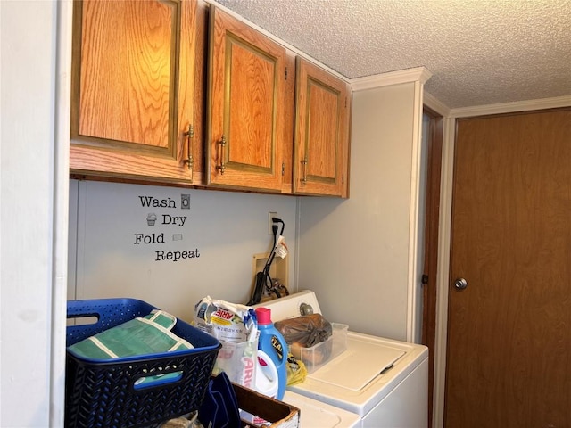 laundry area featuring cabinet space, separate washer and dryer, and a textured ceiling