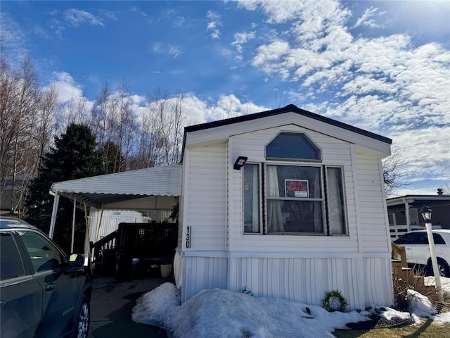 view of side of property with a carport