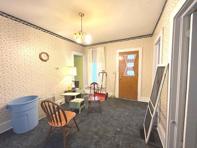 living area with a notable chandelier, baseboards, carpet flooring, and wallpapered walls