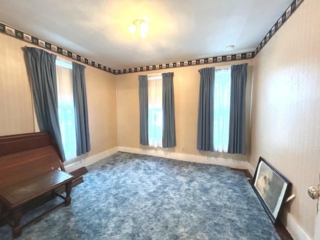 carpeted spare room with baseboards