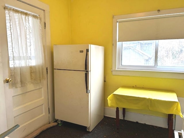 kitchen with plenty of natural light and freestanding refrigerator