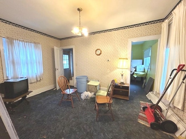 living area featuring wallpapered walls, baseboards, a notable chandelier, and carpet flooring