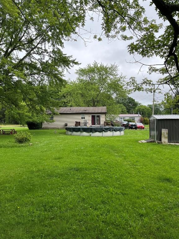 6915 Snodgrass Rd, Jamestown, PA 16134 - view of green lawn featuring a covered pool and an outdoor structure