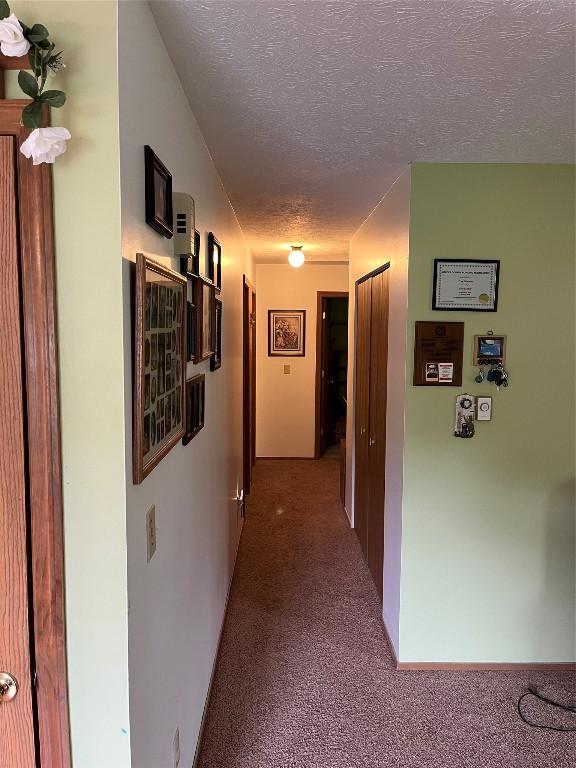 6915 Snodgrass Rd, Jamestown, PA 16134 - hall featuring a textured ceiling and light colored carpet