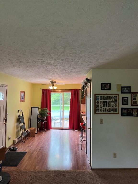 6915 Snodgrass Rd, Jamestown, PA 16134 - living area with a textured ceiling and wood finished floors