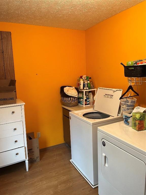 6915 Snodgrass Rd, Jamestown, PA 16134 - laundry area with washer and dryer and wood finished floors