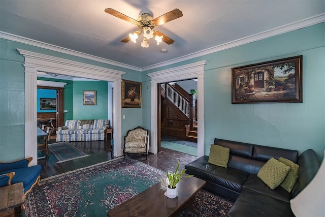 living room featuring decorative columns, crown molding, and ceiling fan