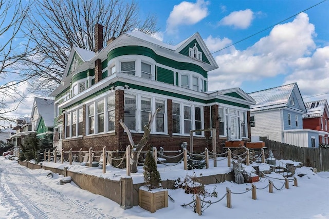 view of snow covered rear of property