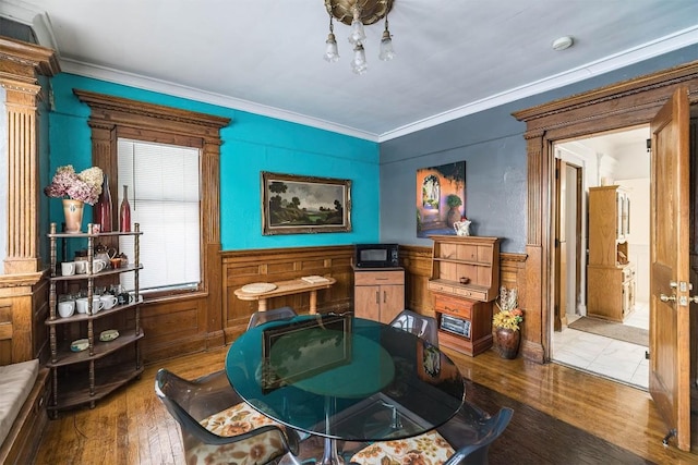 living area with crown molding and wood-type flooring