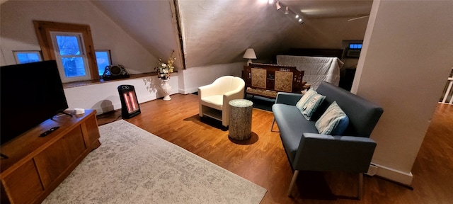 interior space with hardwood / wood-style flooring and lofted ceiling