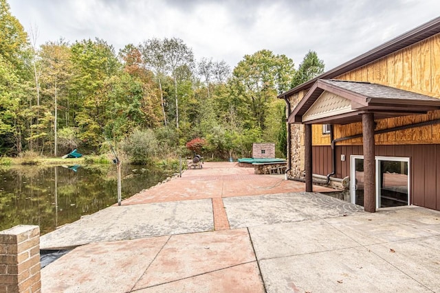 view of patio with a water view