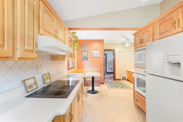 kitchen with tasteful backsplash, light brown cabinetry, white appliances, light countertops, and under cabinet range hood