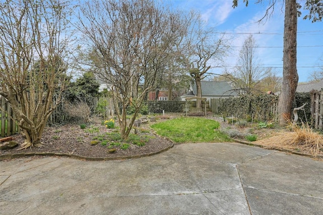 view of yard with fence and a patio