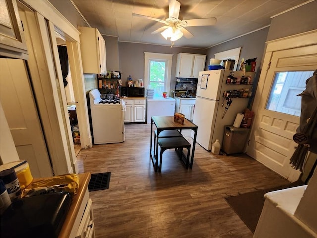 kitchen featuring white appliances, ceiling fan, wood finished floors, and white cabinets