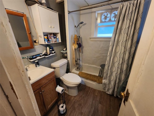 bathroom with vanity, wood finished floors, shower / bath combo, and toilet