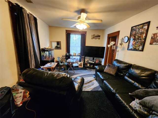 carpeted living area featuring a ceiling fan