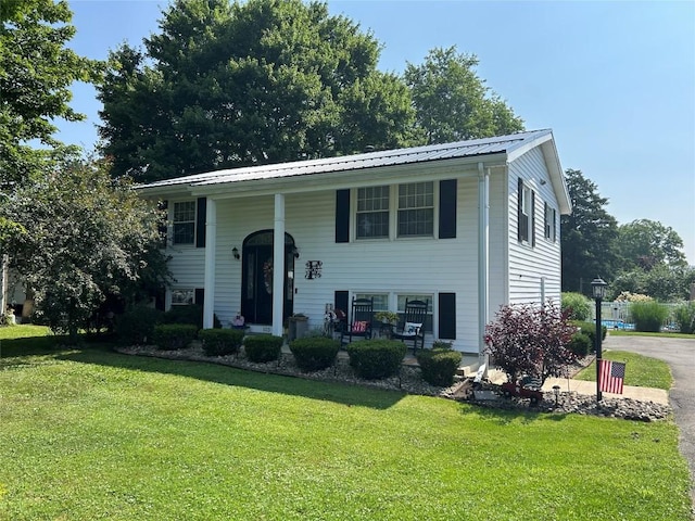 103 S Church St, Linesville, PA 16424 - raised ranch with covered porch, a front yard, and a metal roof