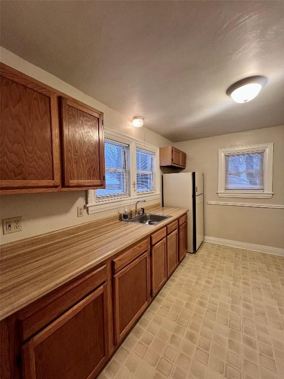 kitchen with white refrigerator and sink