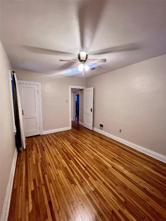 unfurnished bedroom featuring ceiling fan and hardwood / wood-style floors