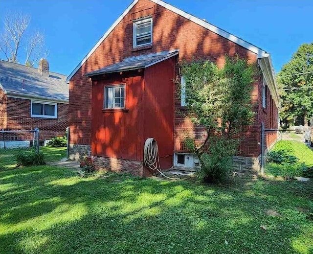 rear view of house featuring a yard