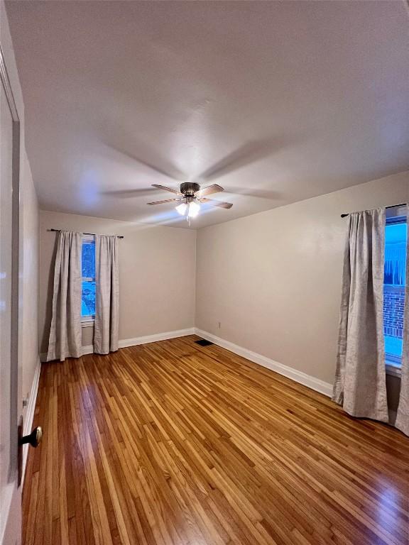 spare room featuring ceiling fan and hardwood / wood-style floors