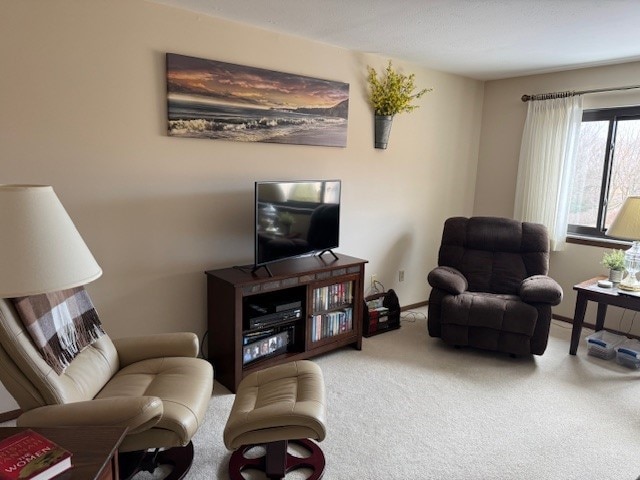 living room featuring carpet floors and baseboards