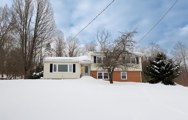 tri-level home featuring brick siding