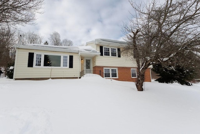 tri-level home with brick siding