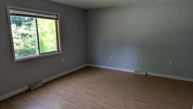 239 Marion St, Corry, PA 16407 - empty room with wood finished floors and baseboards