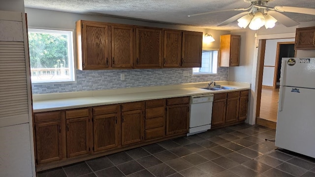 239 Marion St, Corry, PA 16407 - kitchen featuring white appliances, backsplash, healthy amount of natural light, light countertops, and a textured ceiling