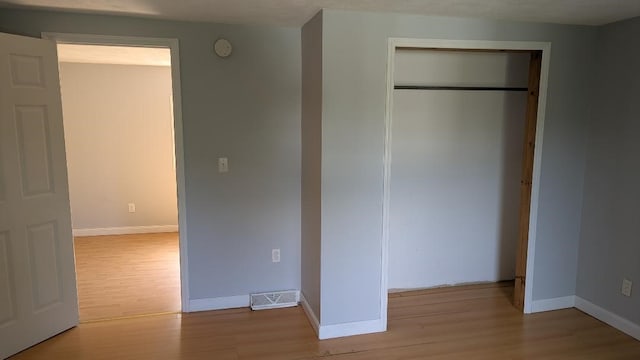 239 Marion St, Corry, PA 16407 - unfurnished bedroom with wood finished floors and a closet