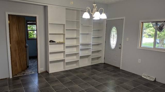239 Marion St, Corry, PA 16407 - entryway featuring a chandelier and dark tile patterned flooring