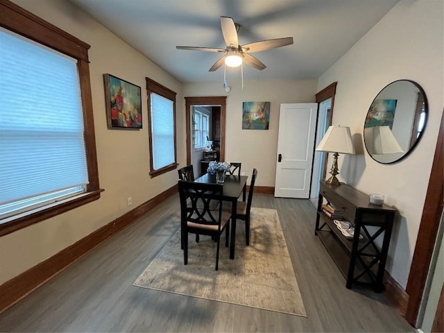 dining space with a wealth of natural light, a ceiling fan, and baseboards