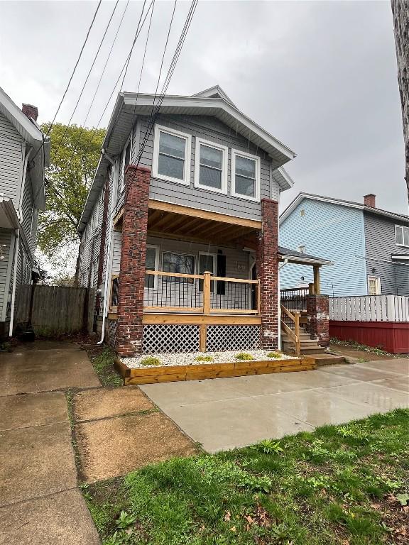 view of front of property with fence and a porch