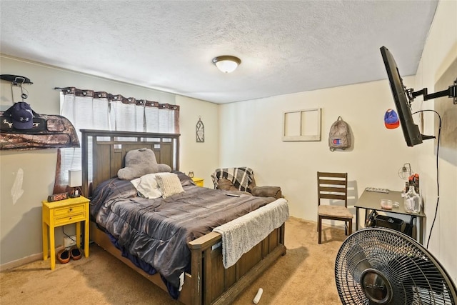 bedroom with light colored carpet and a textured ceiling