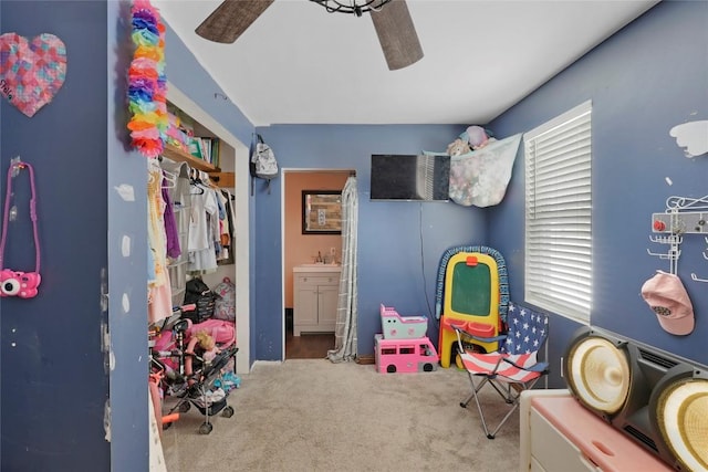 recreation room with carpet floors and ceiling fan