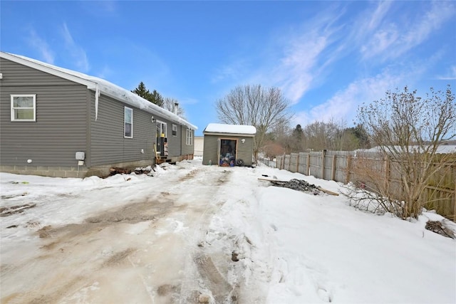 yard layered in snow with an outdoor structure