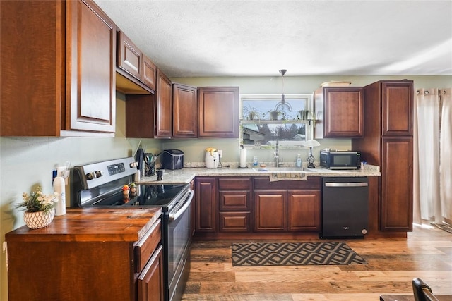 kitchen featuring decorative light fixtures, sink, dishwashing machine, dark wood-type flooring, and stainless steel electric range