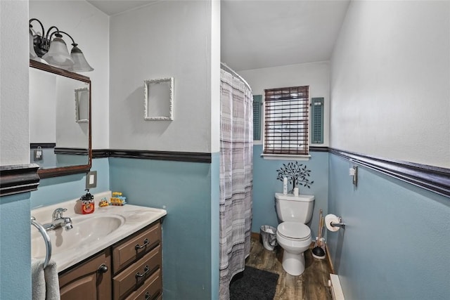 bathroom with vanity, hardwood / wood-style flooring, a shower with curtain, and toilet